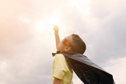 boy with superman cape on being superman