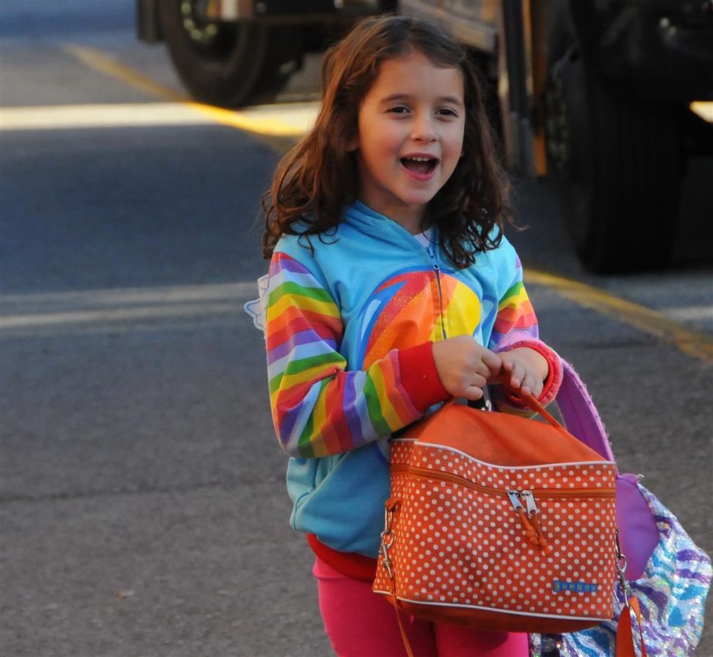 girl carrying lunch bag